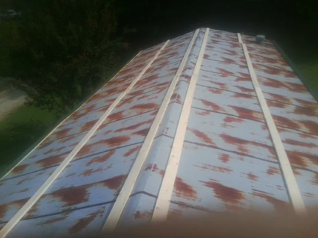 Rusted metal roof panels with new wood purlins before replacement — Storm Damage Roof Repair in New Freedom by Roofing Brothers