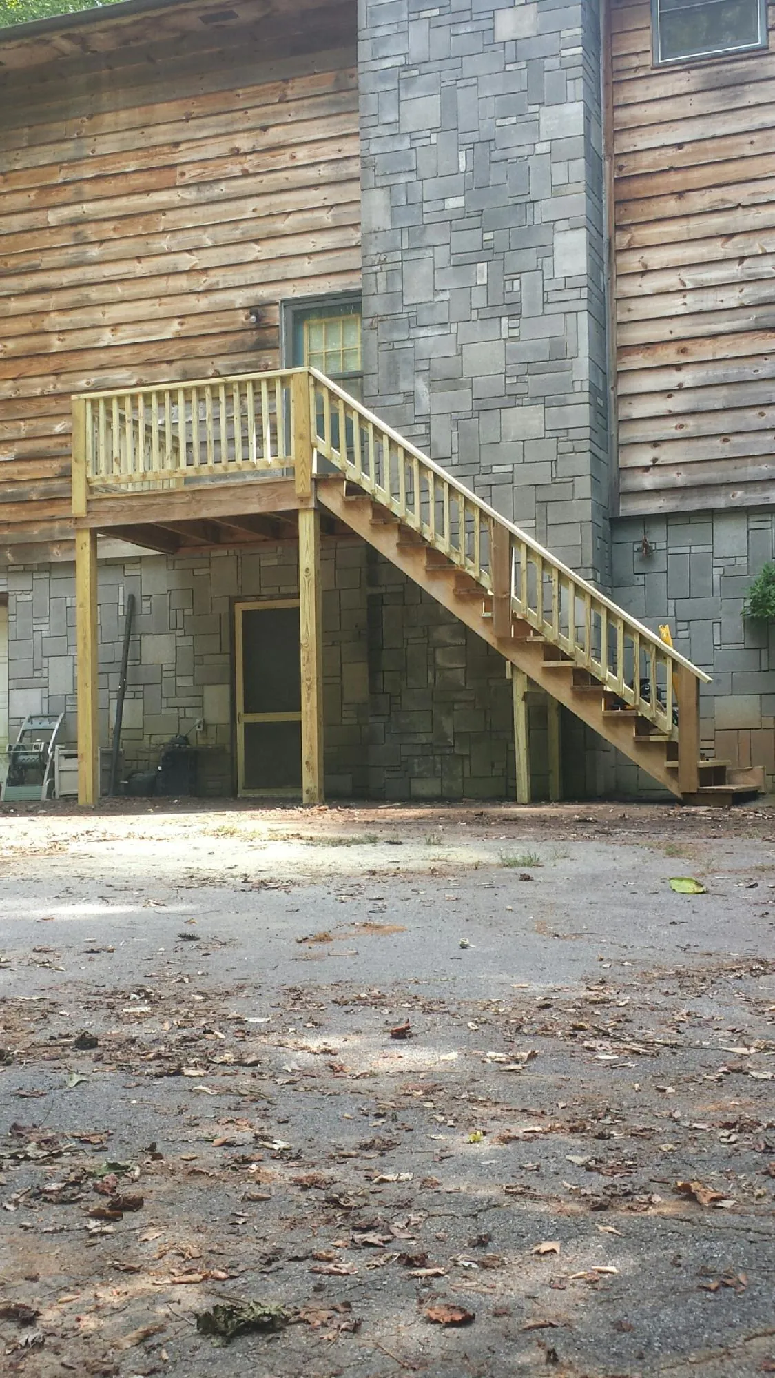 New pressure treated deck and stair landing on a log home in New Freedom