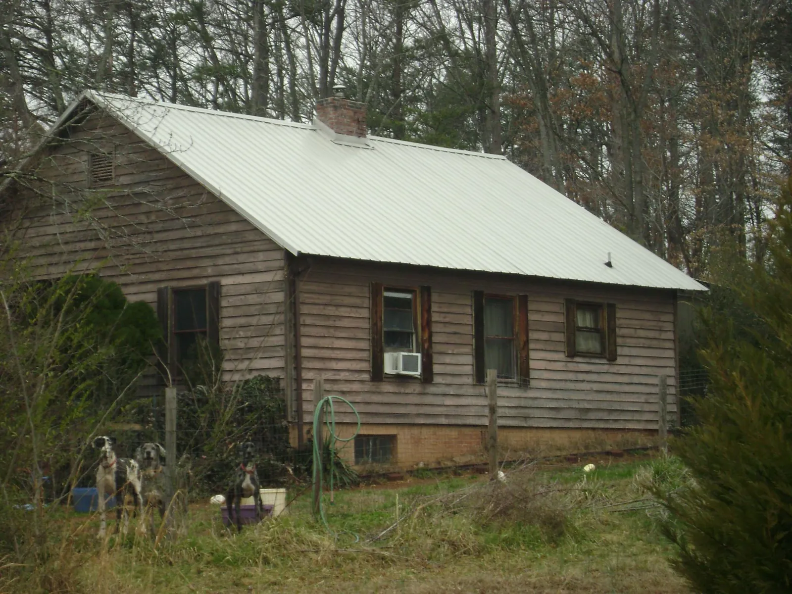 White metal roof on an old wood sided farmhouse, from a Metal Roof Installation job in New Freedom
